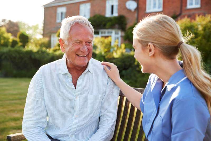 nurse-talking-to-senior-man-in-residential-care