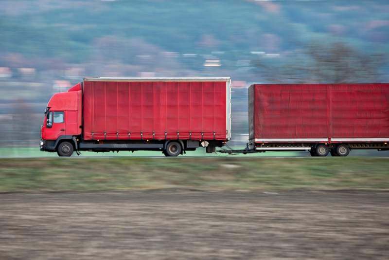 red-camion-truck-goes-fast-on-a-road-panned