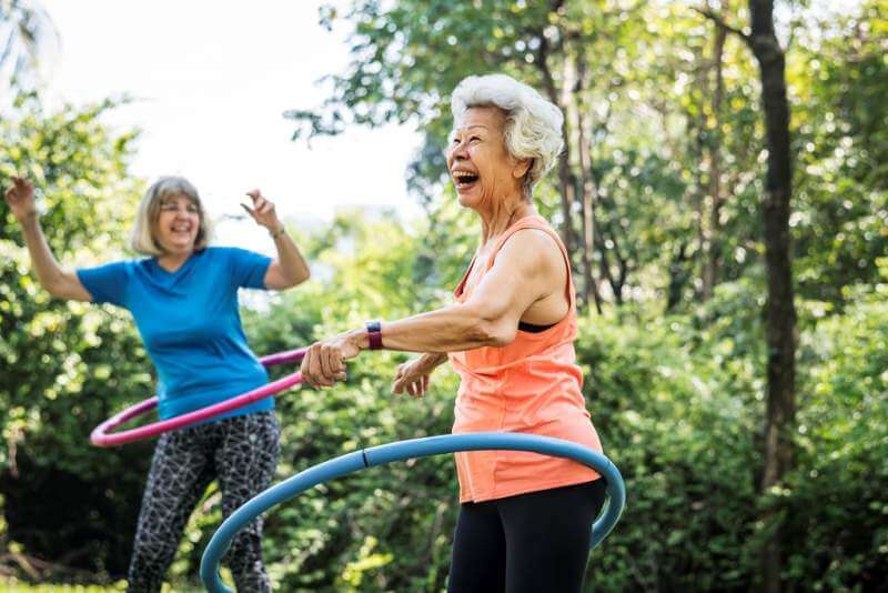 senior-woman-exercising-with-a-hula-hoop