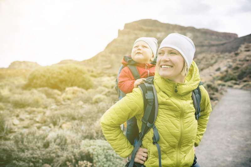 super-mom-with-baby-boy-hiking-in-backpack