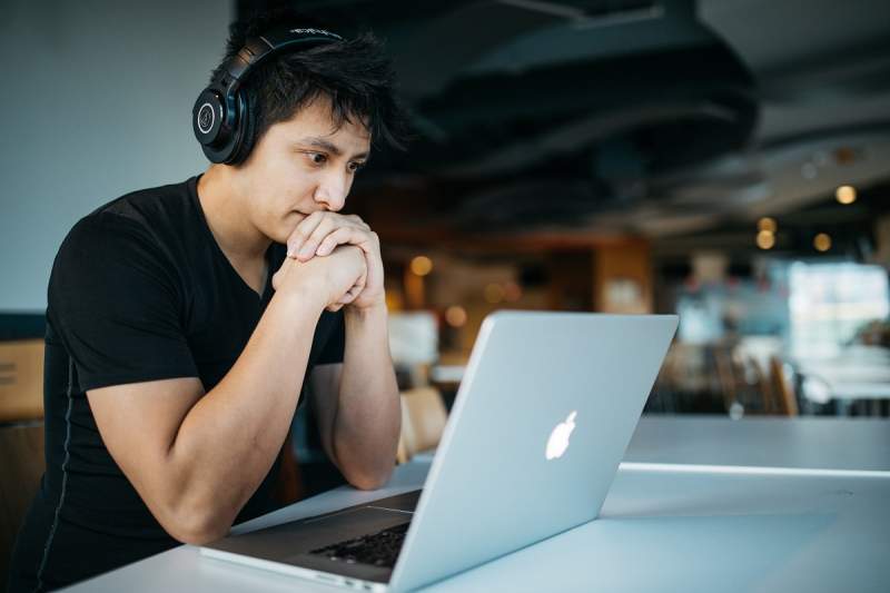 young men thinking laptop