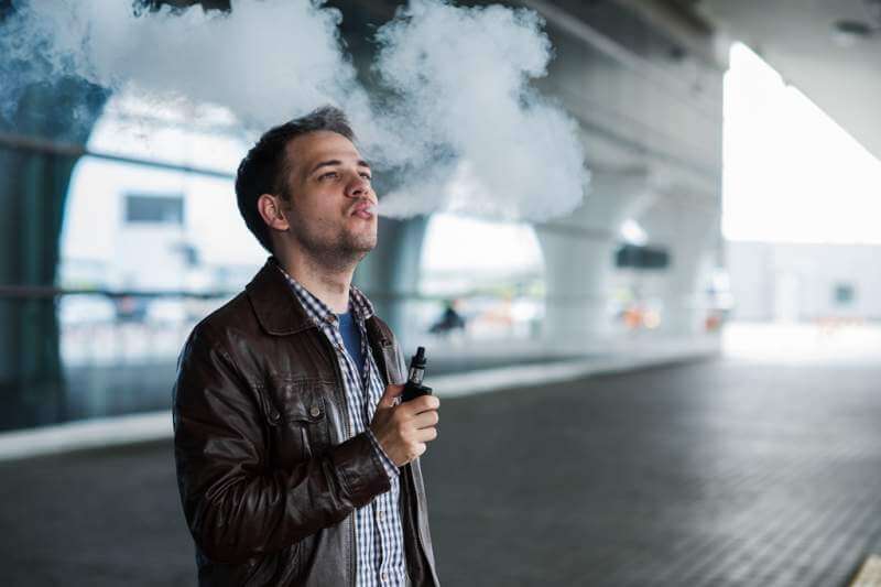 young-traveller-man-smoking-an-electronic