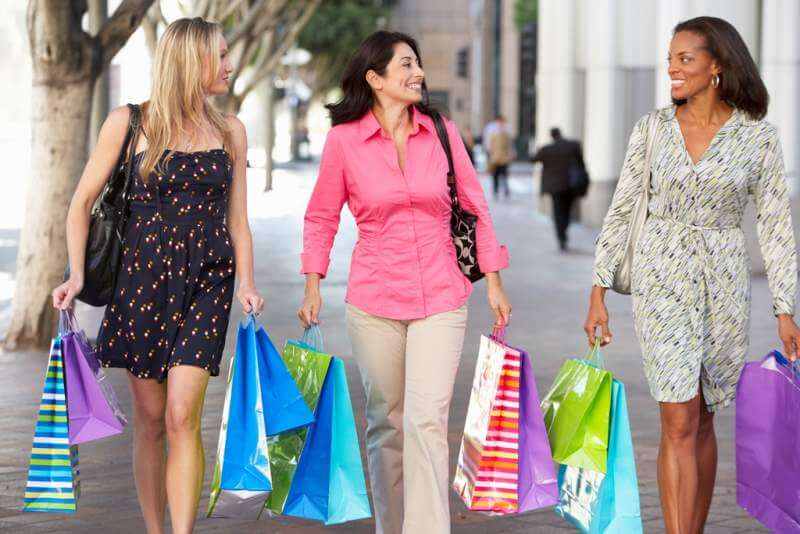 group-of-women-carrying-shopping-bags-on-city