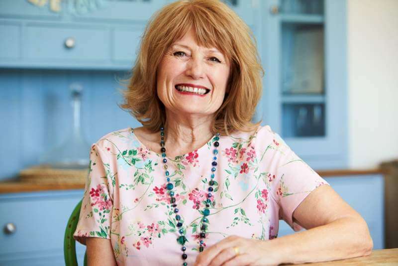 portrait-of-smiling-senior-woman-at-home-sitting