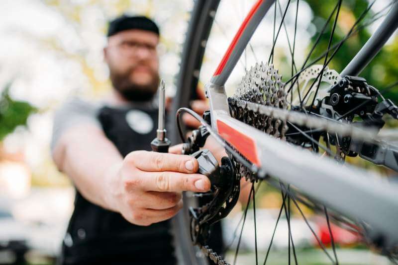 bicycle-mechanic-repair-bike-with-broken-shifter