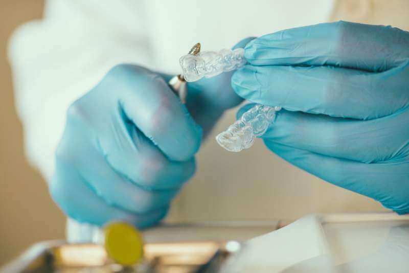 dentist-preparing-invisalign-for-whitening-teeth
