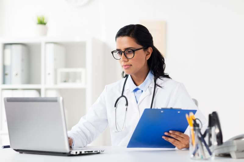 doctor-with-laptop-and-clipboard-at-hospital