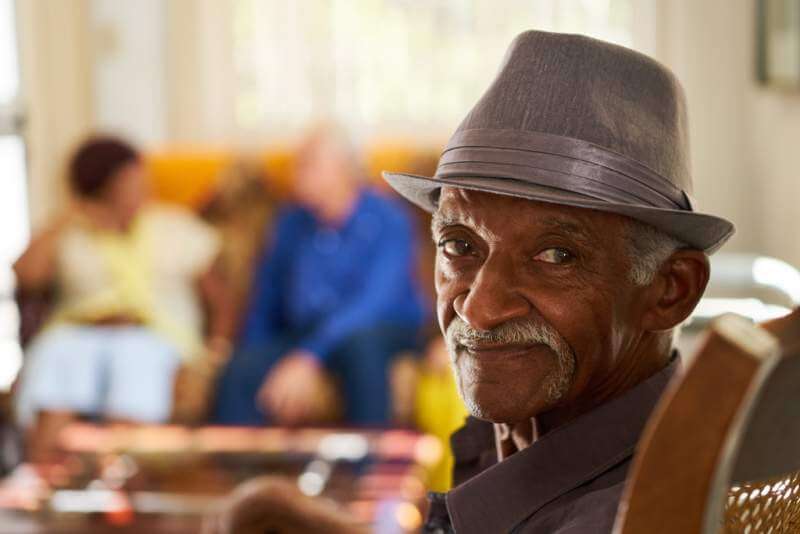 senior-black-man-with-hat-looking-at-camera