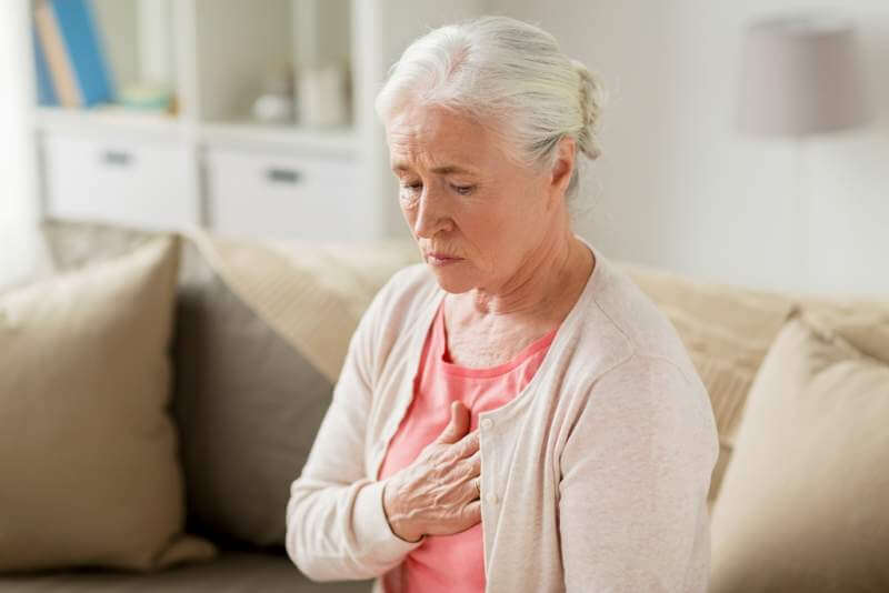 senior-woman-suffering-from-heartache-at-home