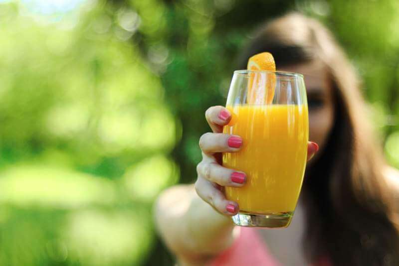 Orange juice glass hands
