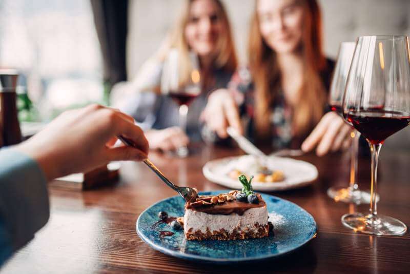 young-women-eats-sweet-cakes-in-restaurant