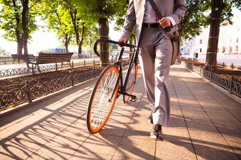 businessman-walking-with-bicycle
