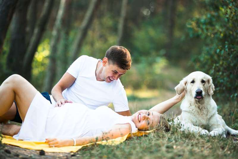 pregnant-woman-with-husband-lying-in-the-park