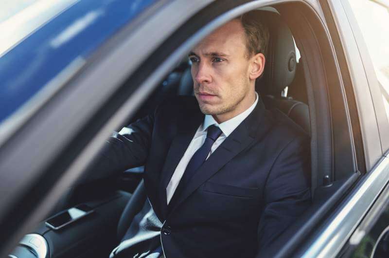 serious-businessman-driving-his-black-stylish-car