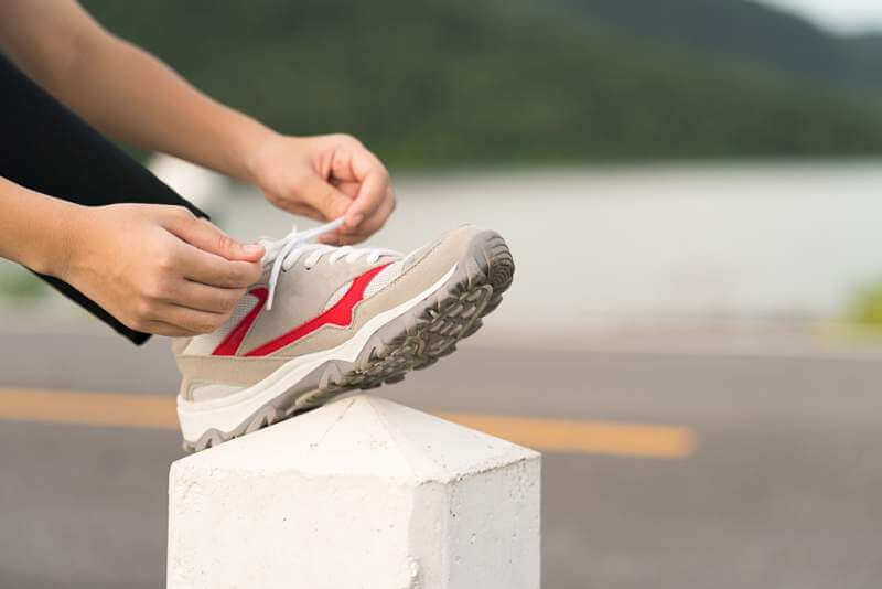 woman-tying-shoelace-his-before-starting-running