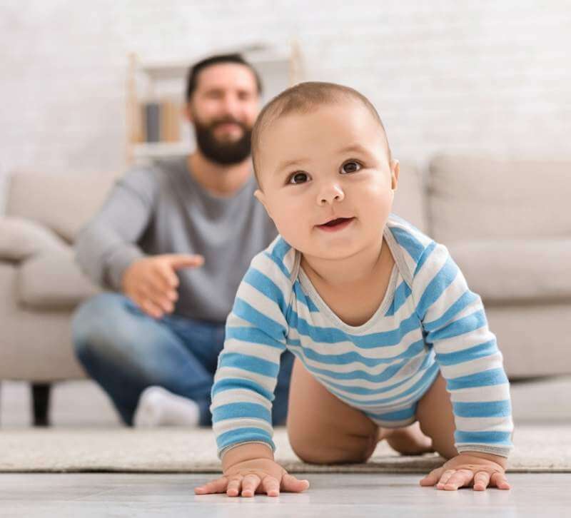 adorable-baby-boy-crawling-on-floor-with-dad