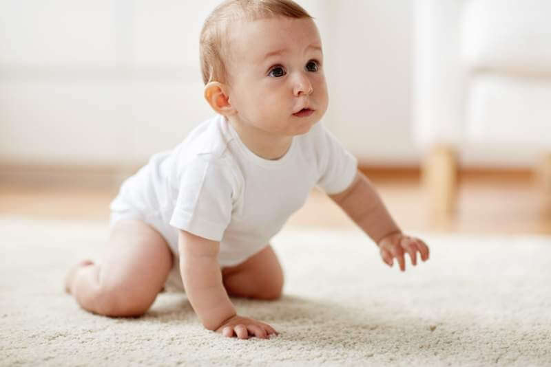 little-baby-in-diaper-crawling-on-floor-at-home
