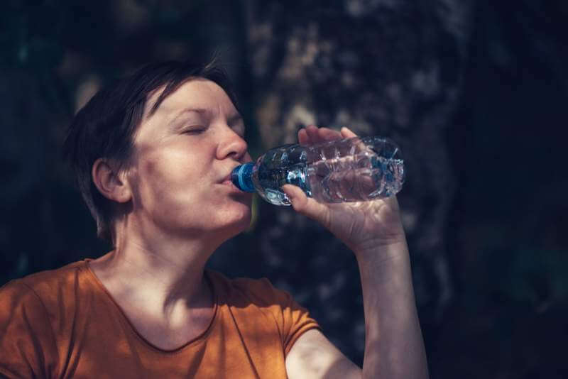 woman-drinking-water-outdoors