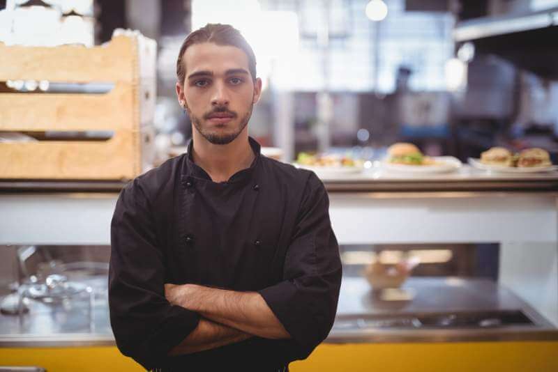 portrait-of-confident-young-waiter-standing