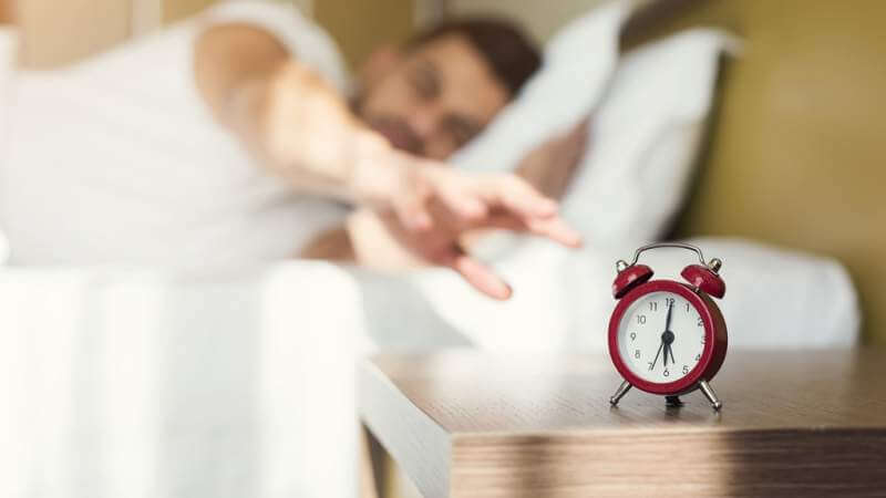 sleepy-guy-waking-up-early-after-alarm-clock