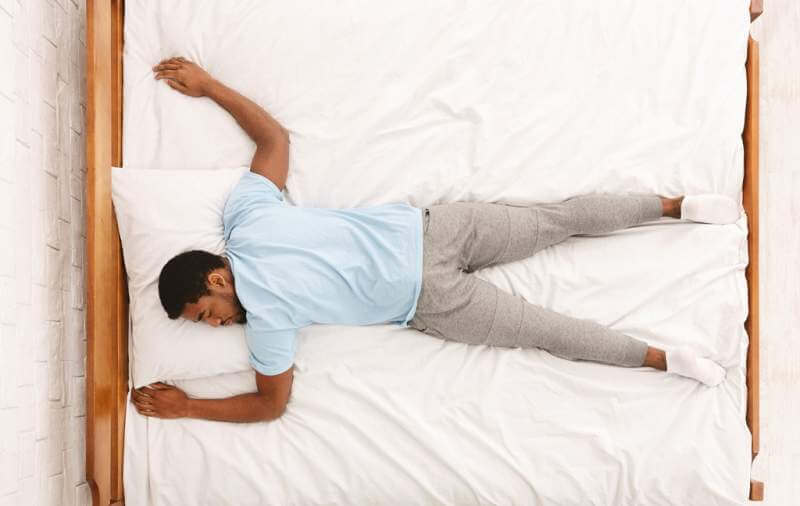 young-african-american-man-sleeping-in-bed-top