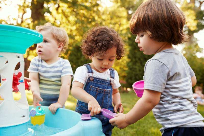 group-of-young-children-playing-with-water-table