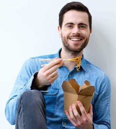 hungry-young-man-smiling-with-chopsticks