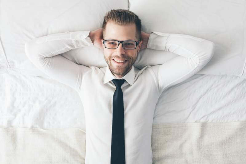 top-view-handsome-businessman-with-glasses-lying