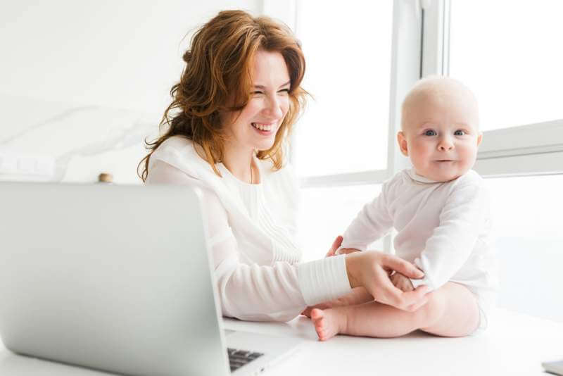 young-cheerful-mom-sitting-happily-looking