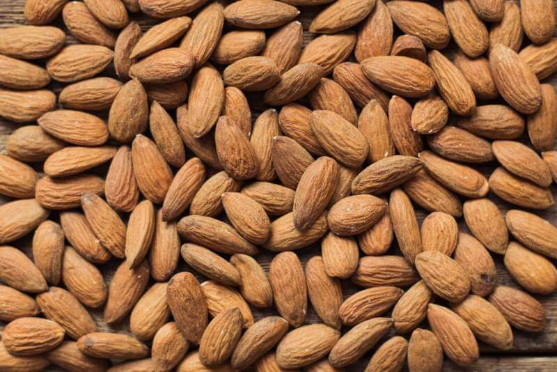 almonds-on-wooden-background