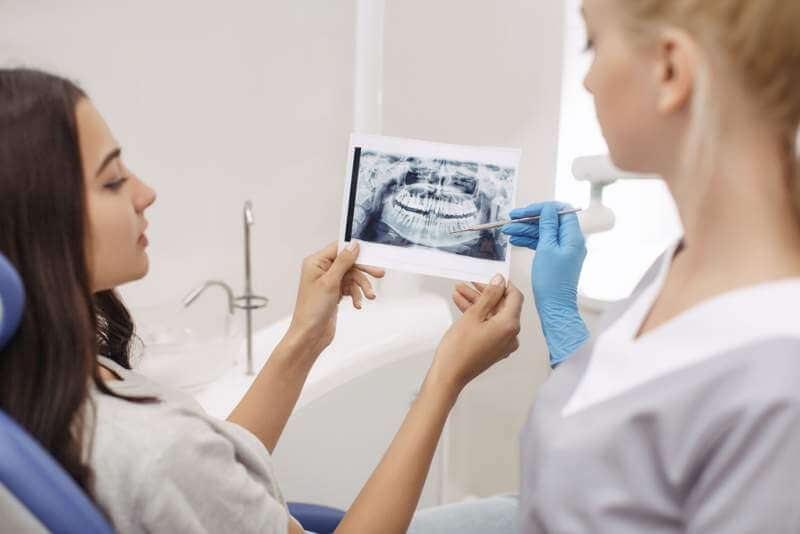 dentist-showing-x-ray-image-to-patient