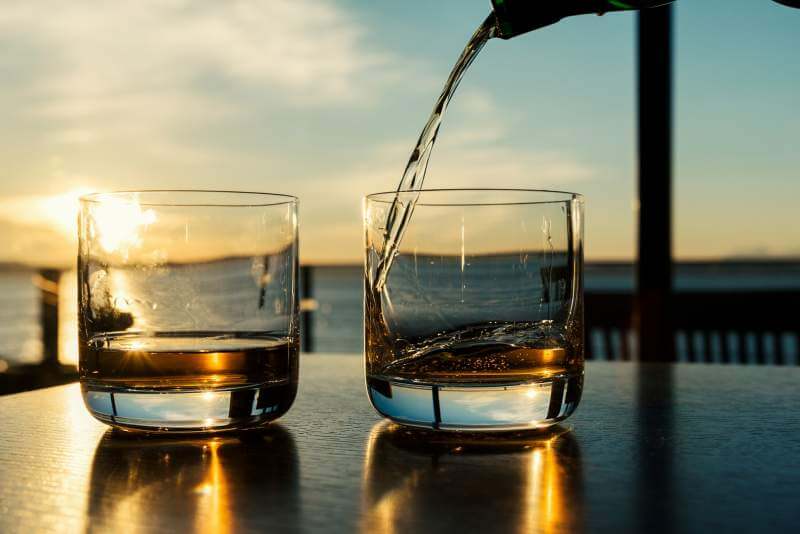 pouring-whiskey-at-sunset